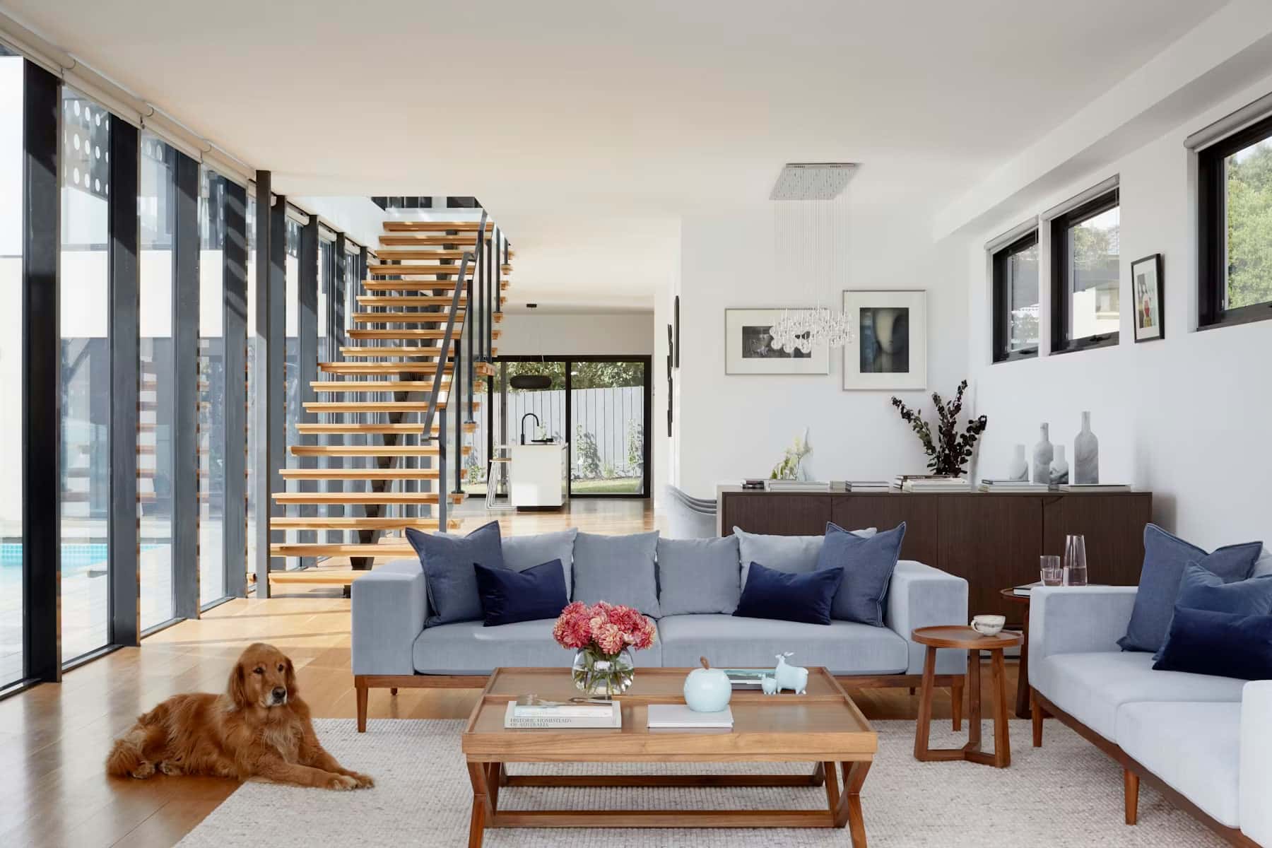Bright open living room with a floating timber staircase